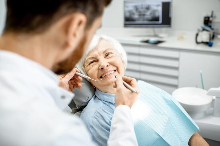 Edentulism - Elderly woman during the medical examination with dentist